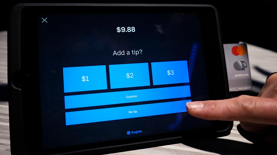Customer puts tip on tablet