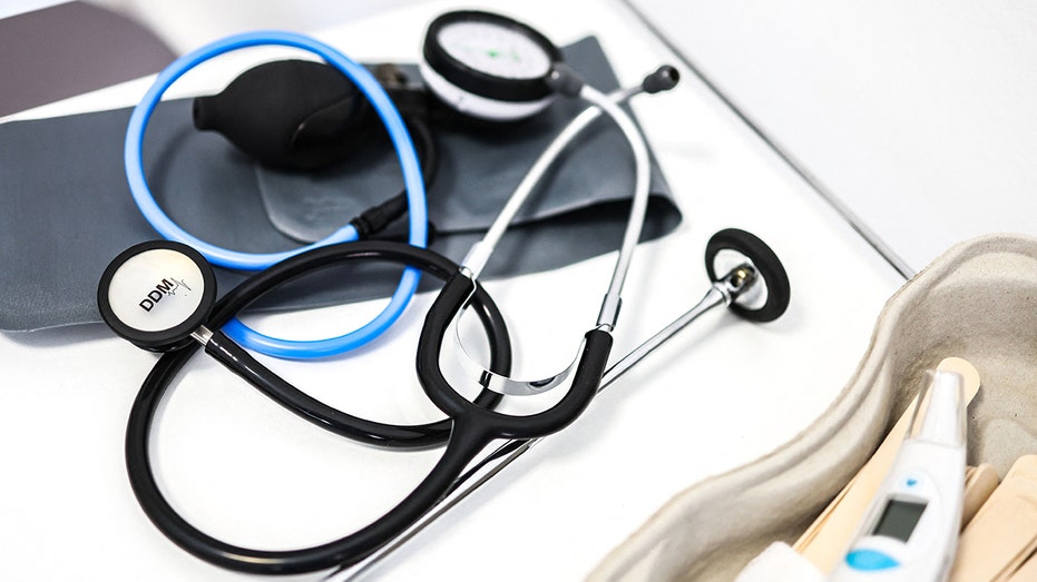 A stethoscope and a thermometer on a table